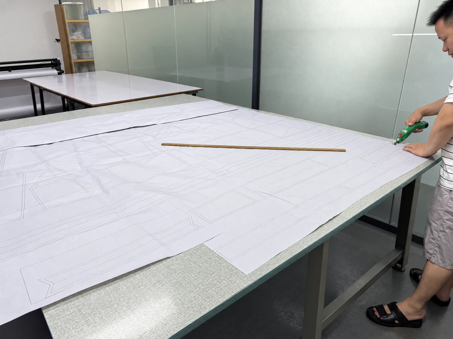A worker prepares garment patterns on a cutting table at Jiashun.
